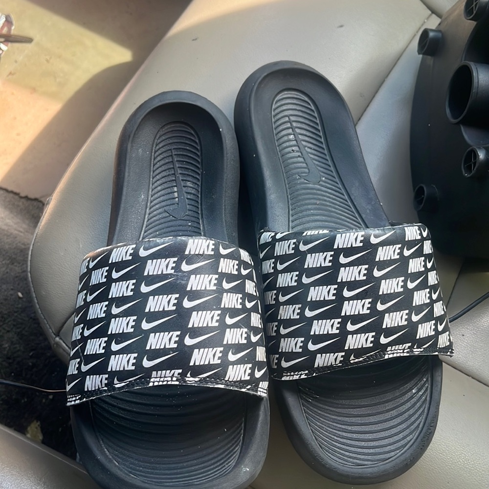 A pair of Nike slides size 11